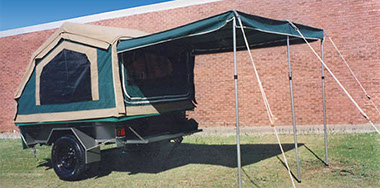 Compact canvas camper trailer with awning up